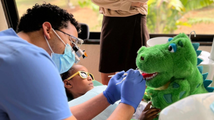Student showing how to floss
